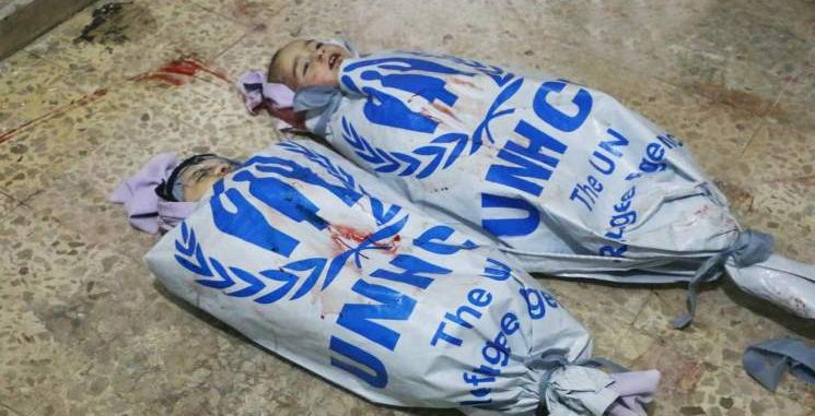 احتجاجاً على تقاعسها …. أهالي غوطة دمشق يلفون جثث قتلاهم بأعلام الأمم المتحدة